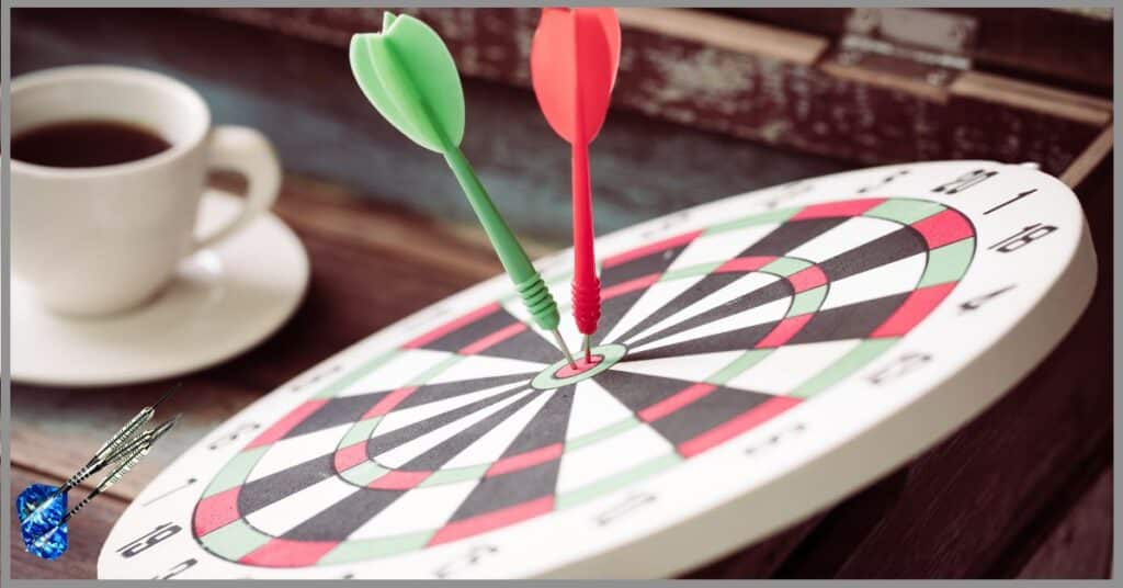 Dartboard with flights on a table and a cup of coffee