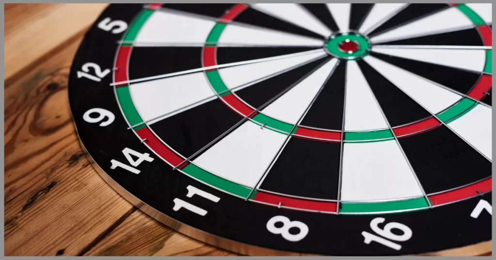 Well-finished dartboard on a wooden table.