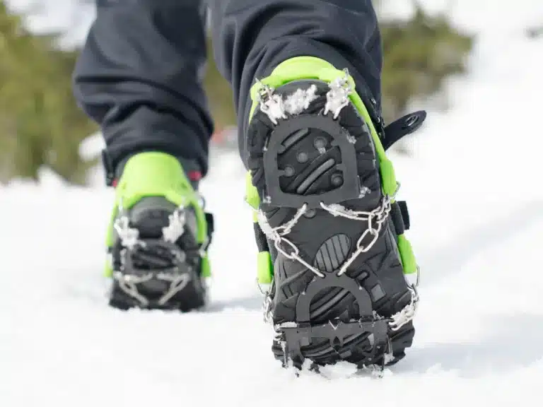 A man walking on ice land with Winter Boots with Retractable Ice Cleats