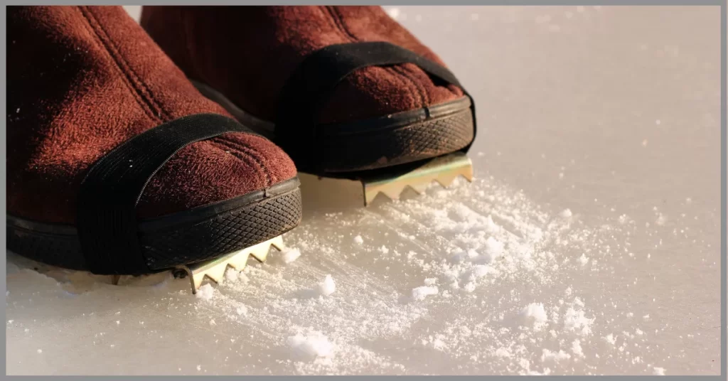 a boot wearing ice cleats and rubbing on the surfacing on ice land