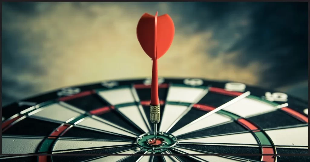 Close-up of a dart hitting the bullseye on a dartboard