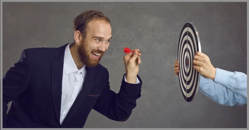 Two men playing a dart game on a board with a smiling face. (what is the most popular dart game to play)