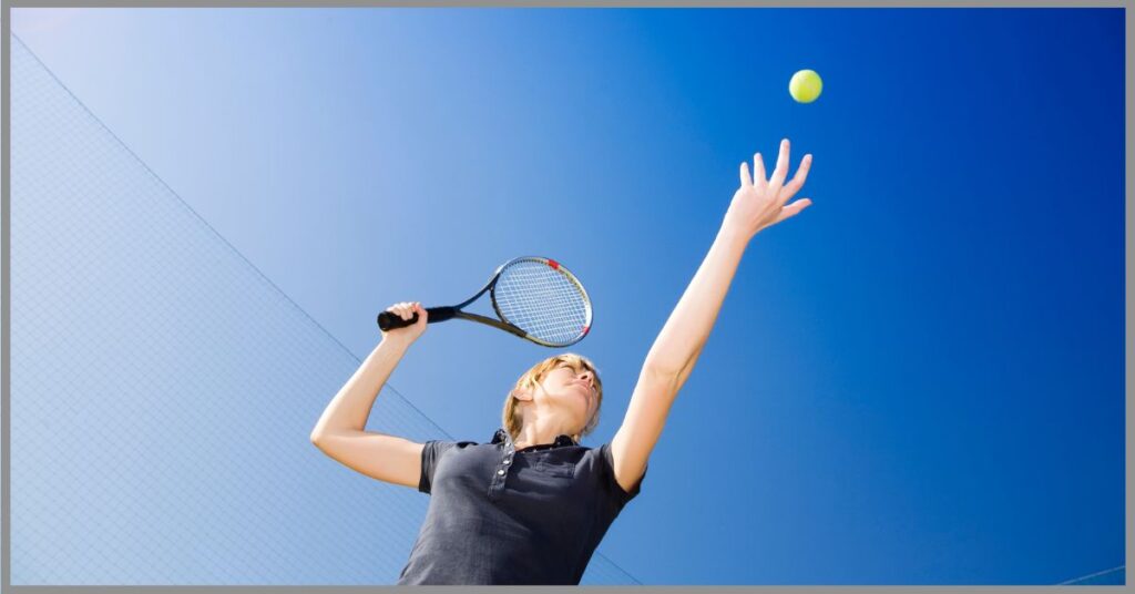 A wealthy woman in a black shirt gracefully playing tennis. (Rich People Sports)