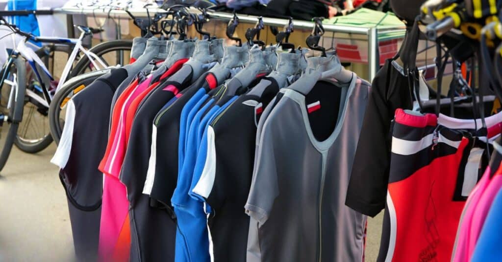  A clothing rack with athletic apparel in various colors and styles.