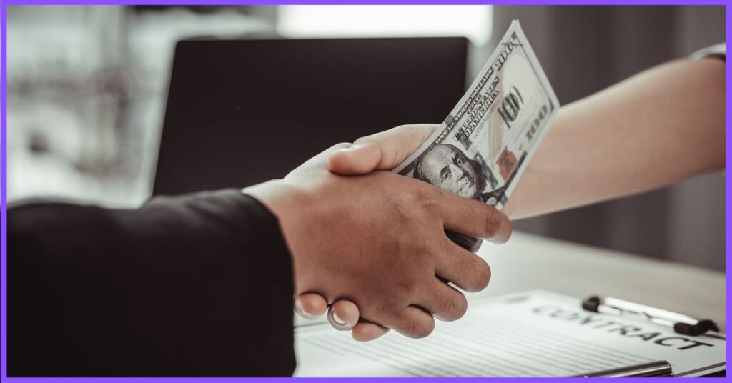 a handover of a money between two people, on a desk with a laptop and a contract. (Are Professional Sports Rigged)