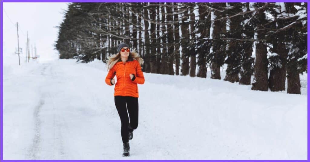 A woman running in ice track, wearing red and black tracksuit 