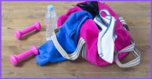 a set of clothes, a purple dumbbell, bottle of water